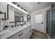 Bright bathroom features a dual sink vanity, modern fixtures, and a stylish glass-enclosed shower at 4234 E Winnetka Dr, Phoenix, AZ 85044
