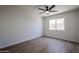 A simple bedroom features sleek wood floors, and a large window for natural light at 4234 E Winnetka Dr, Phoenix, AZ 85044