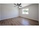 The bright bedroom offers wood flooring, a window view, and neutral color scheme at 4234 E Winnetka Dr, Phoenix, AZ 85044