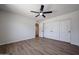 A spare bedroom boasts sleek floors, a ceiling fan and access to the bathroom at 4234 E Winnetka Dr, Phoenix, AZ 85044