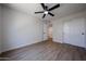This airy bedroom features laminate wood floors, and a ceiling fan for added comfort at 4234 E Winnetka Dr, Phoenix, AZ 85044