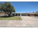 Charming single-story home with a well-manicured lawn and mature shade tree at 4234 E Winnetka Dr, Phoenix, AZ 85044