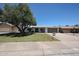 Charming single-story home with mature shade tree, well-kept lawn and covered porch at 4234 E Winnetka Dr, Phoenix, AZ 85044
