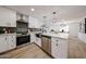 Bright, remodeled kitchen features stainless appliances, white cabinets, quartz countertop island, and modern fixtures at 4234 E Winnetka Dr, Phoenix, AZ 85044