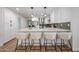 Modern kitchen featuring white cabinets, a large island, and stylish pendant lighting at 4234 E Winnetka Dr, Phoenix, AZ 85044