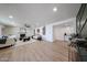 Open-concept living area featuring a white-brick fireplace, neutral furniture, and stylish decor enhancing the inviting ambiance at 4234 E Winnetka Dr, Phoenix, AZ 85044