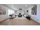 This spacious living room features white sofas, a modern ceiling fan, and light wood floors at 4234 E Winnetka Dr, Phoenix, AZ 85044