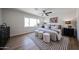 Comfortable primary bedroom featuring a ceiling fan, soft rug and bright, large windows at 4234 E Winnetka Dr, Phoenix, AZ 85044