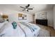 Comfortable primary bedroom featuring a ceiling fan, soft rug and bright, modern art at 4234 E Winnetka Dr, Phoenix, AZ 85044