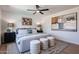 Comfortable primary bedroom featuring a ceiling fan, soft rug and bright, modern art at 4234 E Winnetka Dr, Phoenix, AZ 85044