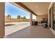 Relaxing back patio with a ceiling fan, leading to a spacious yard and privacy wall at 44157 W Palo Amarillo Rd, Maricopa, AZ 85138