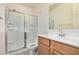 Well-lit bathroom showing a shower with glass door, sink, toilet, and tiled floor at 44157 W Palo Amarillo Rd, Maricopa, AZ 85138
