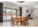 Dining area with a wooden table, chairs, and sliding glass doors at 44157 W Palo Amarillo Rd, Maricopa, AZ 85138