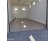 Spacious and clean garage boasts an epoxy floor and multiple windows, offering ample natural light at 44157 W Palo Amarillo Rd, Maricopa, AZ 85138