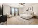 Bedroom with neutral walls, carpet, window, ceiling fan, and modern decor at 44157 W Palo Amarillo Rd, Maricopa, AZ 85138