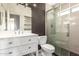 Updated bathroom featuring a marble countertop vanity, modern fixtures, and a glass-enclosed shower at 4434 E Bannock St, Phoenix, AZ 85044