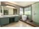 Stylish bathroom with modern fixtures, dual sinks, a soaking tub, and a glass-enclosed shower at 4434 E Bannock St, Phoenix, AZ 85044