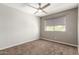Neutral bedroom with carpet, a ceiling fan and a window offering natural light, ready for personalization at 4434 E Bannock St, Phoenix, AZ 85044
