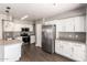 Bright kitchen with stainless steel appliances, white cabinets, and modern countertops at 4434 E Bannock St, Phoenix, AZ 85044