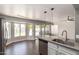 Open-concept kitchen featuring a quartz counter, stainless steel appliances, and view of backyard at 4434 E Bannock St, Phoenix, AZ 85044