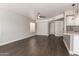 Open living space with a ceiling fan, wood floors, and views into the kitchen at 4434 E Bannock St, Phoenix, AZ 85044