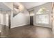 Spacious living room with dark wood floors, light gray walls, and large windows for natural light at 4434 E Bannock St, Phoenix, AZ 85044