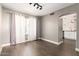 Cozy living room showcasing wood floors, neutral decor, and an open archway leading to the kitchen at 4434 E Bannock St, Phoenix, AZ 85044