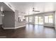 Bright, open-concept living space with wood floors, backyard views, and a kitchen bar area at 4434 E Bannock St, Phoenix, AZ 85044