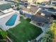 Aerial view showcasing the pool, covered patio, and well-maintained backyard of this lovely home at 4644 W Berridge Ln, Glendale, AZ 85301