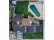 Aerial view of a home showing a rectangular pool, lawn, and multiple vehicles parked in the driveway at 4644 W Berridge Ln, Glendale, AZ 85301