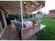 Charming covered back patio with decorative lighting and outdoor seating perfect for relaxing at 4644 W Berridge Ln, Glendale, AZ 85301