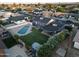 Expansive backyard highlighting a refreshing pool, a well-manicured lawn, and beautiful greenery for relaxation at 4644 W Berridge Ln, Glendale, AZ 85301