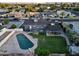 Lush backyard showcasing a sparkling pool, a generous lawn area, and a covered patio ideal for outdoor living at 4644 W Berridge Ln, Glendale, AZ 85301