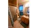 Cozy bathroom featuring a shower, granite countertop, and a window with blue curtains at 4644 W Berridge Ln, Glendale, AZ 85301