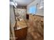 Stylish bathroom with a granite countertop, decorative tile, and a shower-tub combination at 4644 W Berridge Ln, Glendale, AZ 85301