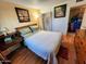 Bedroom featuring wood flooring, neutral walls, and framed decor at 4644 W Berridge Ln, Glendale, AZ 85301