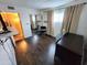 A bedroom with hardwood floors and a large mirrored closet with a view into another room at 4644 W Berridge Ln, Glendale, AZ 85301