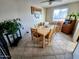 The cozy dining room has tile floors, a light wood table with seating for six, and a ceiling fan at 4644 W Berridge Ln, Glendale, AZ 85301