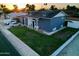 Charming single-Gathering house with a well-maintained front yard and a welcoming facade on a tree-lined street at 4644 W Berridge Ln, Glendale, AZ 85301