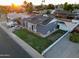 Well-kept single-Gathering home featuring a tidy front lawn and neutral exterior paint in a peaceful community at 4644 W Berridge Ln, Glendale, AZ 85301