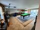 Spacious game room featuring a pool table, fireplace, and a partial view of an adjacent living area at 4644 W Berridge Ln, Glendale, AZ 85301