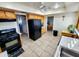 Spacious kitchen featuring a black refrigerator, gas range, and ample cabinet space at 4644 W Berridge Ln, Glendale, AZ 85301