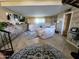 Spacious living room features tile floors, a brick accent wall, and comfortable sofas at 4644 W Berridge Ln, Glendale, AZ 85301