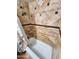 Close-up of the tiled shower area with built-in shelves and a floral shower curtain at 4644 W Berridge Ln, Glendale, AZ 85301
