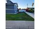 Side yard with green lawn and a white brick fence at 4644 W Berridge Ln, Glendale, AZ 85301