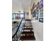 View of wooden stairs with decorative Gathering photos and the living room from above at 4644 W Berridge Ln, Glendale, AZ 85301