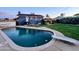 Inviting swimming pool and diving board with backyard patio and two-story home at dusk at 4644 W Berridge Ln, Glendale, AZ 85301