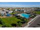 Aerial shot displays a large community pool, playground, verdant green spaces, and neatly arranged homes at 5741 W Warner St, Phoenix, AZ 85043