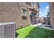 This backyard has artificial turf, a paver patio, and an outdoor seating area, perfect for grilling and relaxation at 5741 W Warner St, Phoenix, AZ 85043