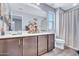 Bathroom with a double sink vanity, lots of counter space, white sink basins and dark cabinets at 5741 W Warner St, Phoenix, AZ 85043